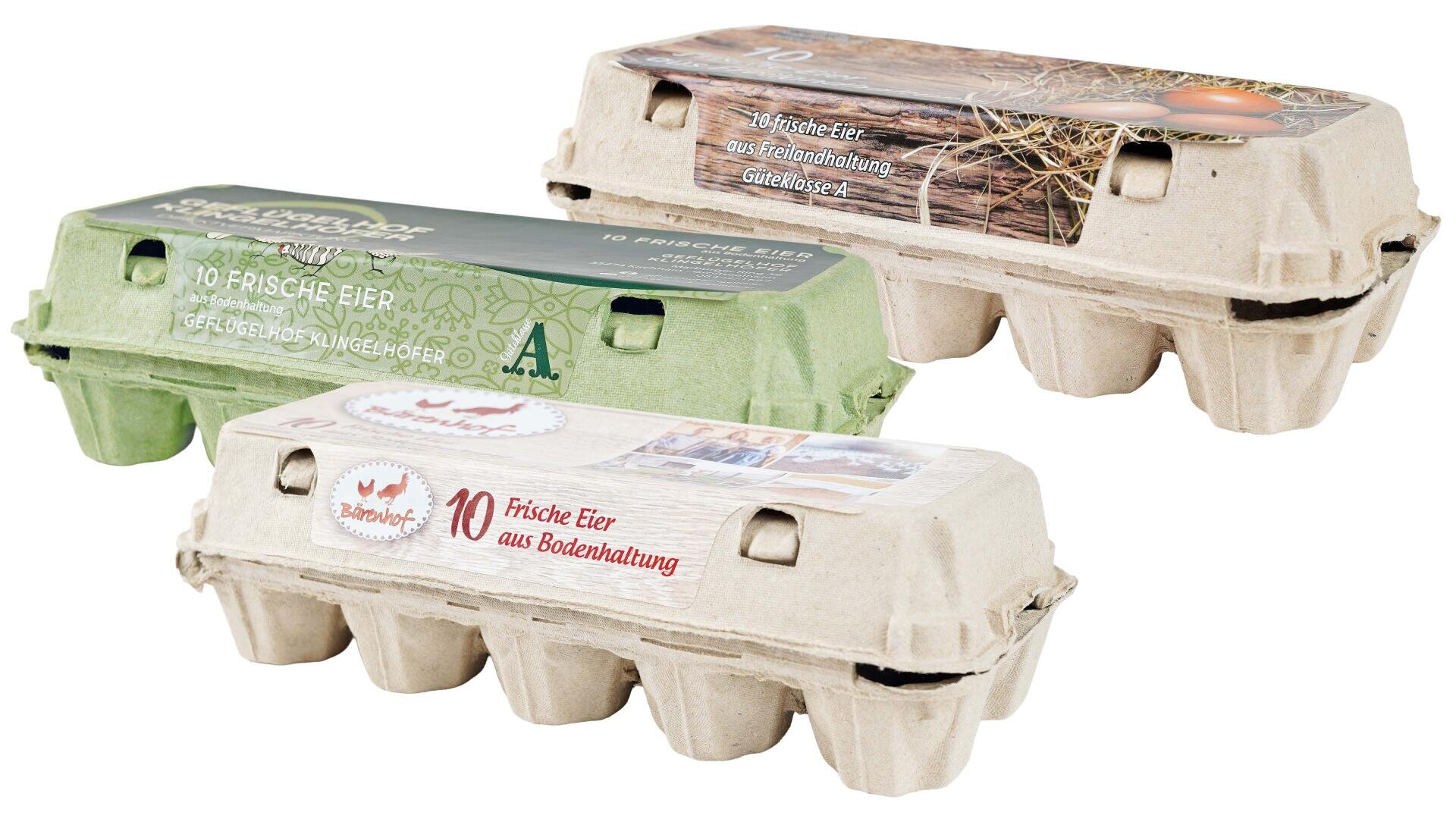 Three cartons of eggs with German labels, each made of cardboard in different colors: green, brown and white. The cartons are labeled with the number 10 and various product information.