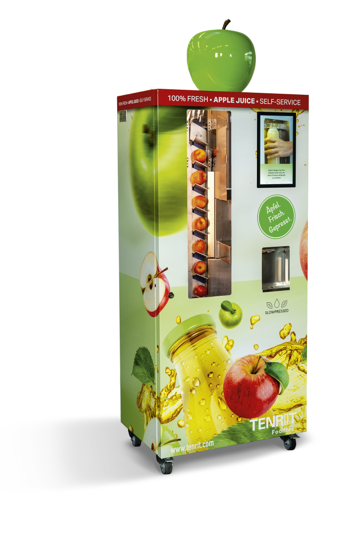 Ein mit Apfelbildern dekorierter Verkaufsautomat mit einem Bildschirm, einem Saftausgabebereich und einem großen grünen Apfelmodell obenauf. Der Automat wirbt für frischen Apfelsaft zur Selbstbedienung.